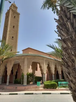 a building with a clock tower on top of it at Riad Camélia in Marrakech