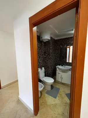 a bathroom with a toilet and a sink at Charmant Appartement à Gueliz in Marrakech