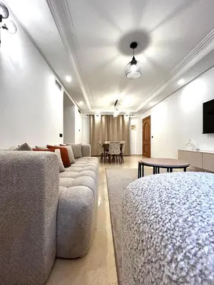 a living room with a couch and a table at Charmant Appartement à Gueliz in Marrakech