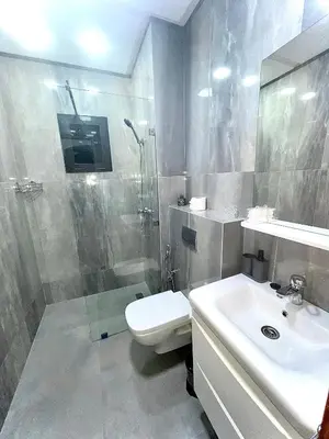 a bathroom with a toilet and a sink and a shower at Appartement LILIA in Marrakech