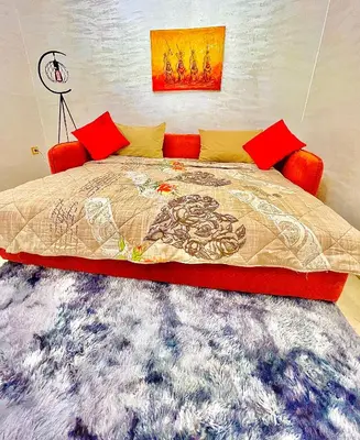 a bedroom with a large bed with a rug at Appartement LILIA in Marrakech