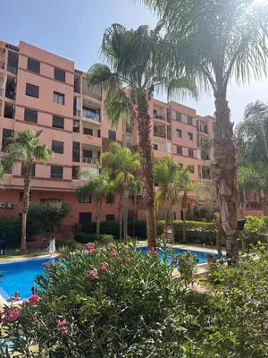 a large building with palm trees and a swimming pool at Luxury Duplex for Rent Suites,terrace,Swimimg Pool in Marrakech