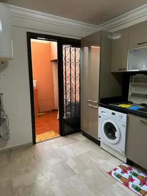 a kitchen with a washer and dryer in a room at Luxury Duplex for Rent Suites,terrace,Swimimg Pool in Marrakech