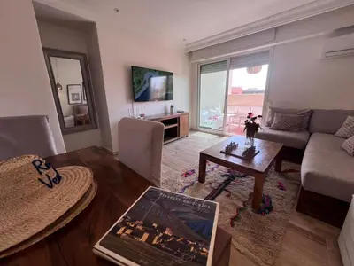 a living room with a couch and a table at RoofTop avec Terrasse Centre Gueliz in Marrakech