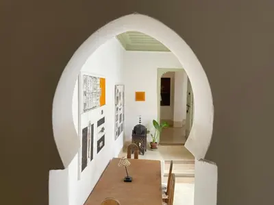 a dining room with a table and an archway at Dar Ibo- Entire House- in Marrakech