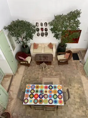 a living room with a couch and a table at Dar Ibo- Entire House- in Marrakech