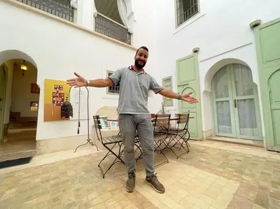 a man standing in front of a building with his arms out at Dar Ibo- Entire House- in Marrakech