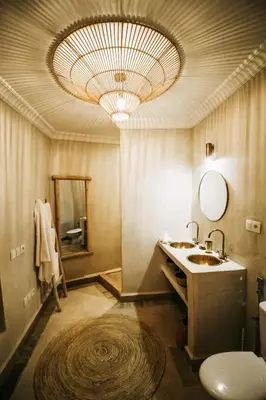 a bathroom with a sink and a large chandelier at Riad Shabi Kasbah in Marrakech