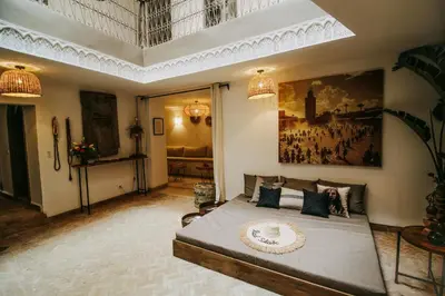 a bedroom with a bed and a painting on the wall at Riad Shabi Kasbah in Marrakech