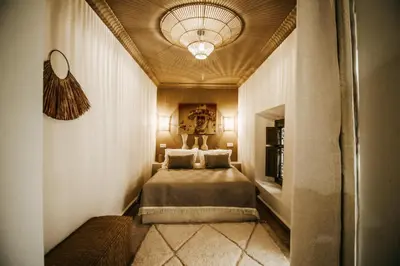 a bedroom with a bed and a ceiling at Riad Shabi Kasbah in Marrakech