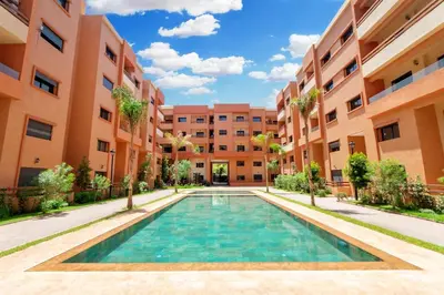 a swimming pool in the middle of a building at Appartement en résidence fermée in Marrakech