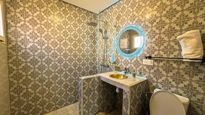 a bathroom with a sink and a mirror at Riad Beldi Chic Un Séjour Authentique Proche Médina in Marrakech