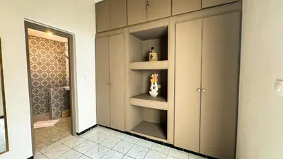 a bathroom with a walk in shower and a closet at Riad Beldi Chic Un Séjour Authentique Proche Médina in Marrakech