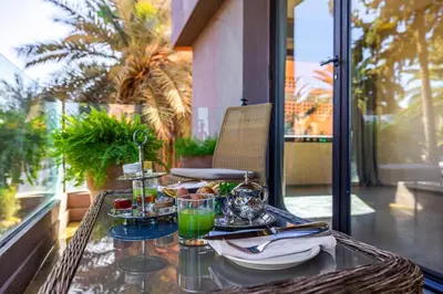 a table with a tray of food on a balcony at Luxury 2 BDR Hivernage in Marrakech