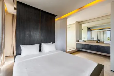 a bedroom with a large white bed and a bathroom at Luxury 2 BDR Hivernage in Marrakech