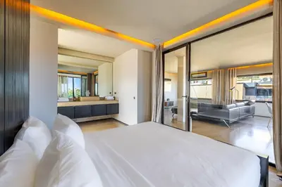 a bedroom with a large white bed and a bathroom at Luxury 2 BDR Hivernage in Marrakech