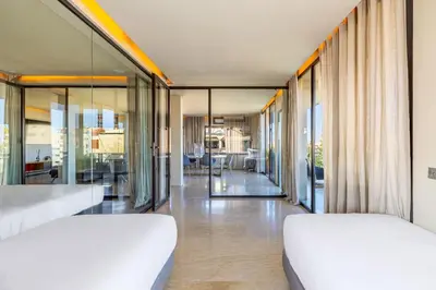 two beds in a room with sliding glass doors at Luxury 2 BDR Hivernage in Marrakech