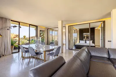 a living room with a couch and a table with chairs at Luxury 2 BDR Hivernage in Marrakech