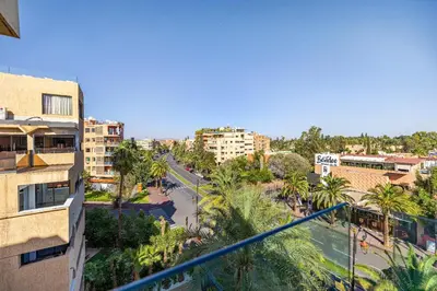 a view of a city with palm trees and buildings at Luxury 2 BDR Hivernage in Marrakech