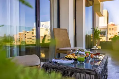 a table with a bowl of fruit on a balcony at Luxury 2 BDR Hivernage in Marrakech