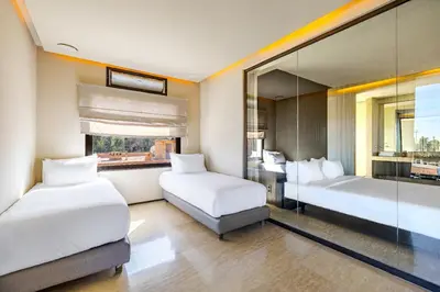 a hotel room with two beds and a mirror at Luxury 2 BDR Hivernage in Marrakech