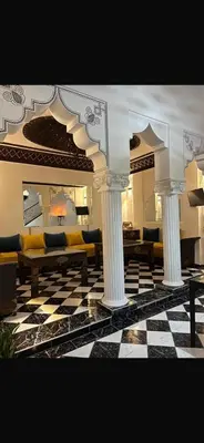 a living room with couches and a checkered floor at Riad Nolya Luxury Marrakech - Totalement Rénové - Capacité jusqu à 10 lits spacieux in Marrakech