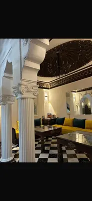a living room with white columns and a couch at Riad Nolya Luxury Marrakech - Totalement Rénové - Capacité jusqu à 10 lits spacieux in Marrakech