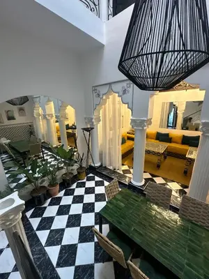 a living room with a checkered floor and a chandelier at Riad Nolya Luxury Marrakech - Totalement Rénové - Capacité jusqu à 10 lits spacieux in Marrakech