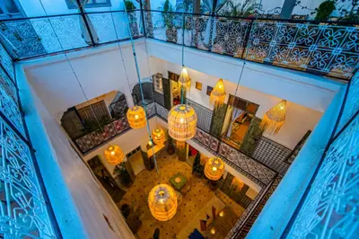 an overhead view of a balcony with orange lights at Riad Bab Taghzout Marrakech in Marrakech