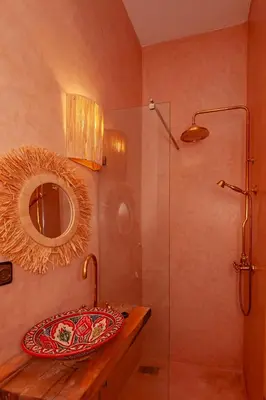 a bathroom with a sink and a shower with a mirror at Riad Bab Taghzout Marrakech in Marrakech