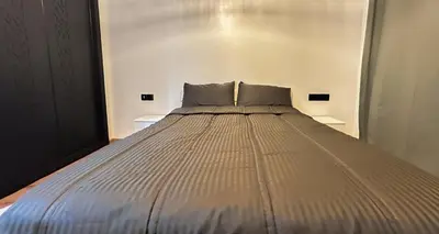 a large bed sitting in a room with at Luxe et Douceur moderne, Parking Privé in Marrakech
