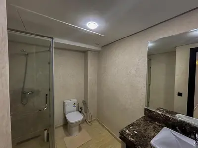 a bathroom with a shower and a toilet and a sink at Luxe et Douceur moderne, Parking Privé in Marrakech