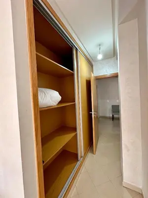a room with a closet with a bed in it at Chambre salon à avenue med 6 centre de gueliz 10 in Marrakech