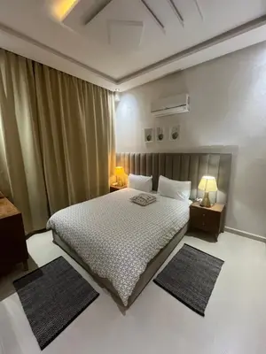 a bedroom with a bed and two rugs in it at Dar Amina in Marrakech