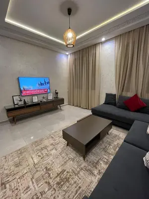 a living room with a couch and a flat screen tv at Dar Amina in Marrakech