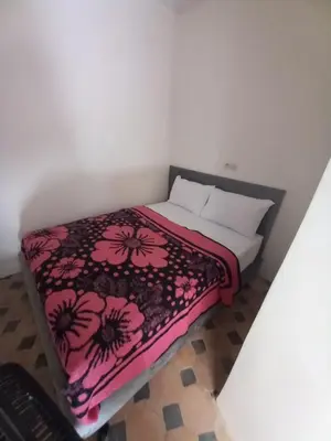 a bedroom with a bed with a pink and black blanket at Juli's in Marrakech