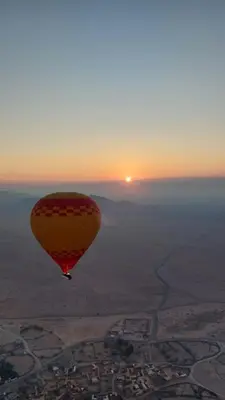 a hot air balloon flying in the sky at sunset at Juli's in Marrakech