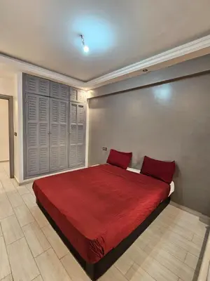 a bedroom with a large red bed with red pillows at Guéliz Penthouse in Marrakech