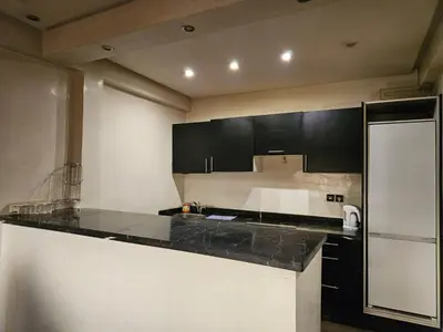 a kitchen with black cabinets and a black counter top at Guéliz Penthouse in Marrakech