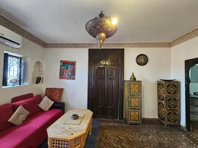 a living room with a red couch and a table at Guéliz Penthouse in Marrakech