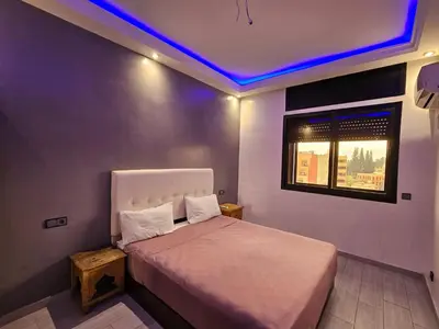 a bedroom with a bed with a purple ceiling at Guéliz Penthouse in Marrakech