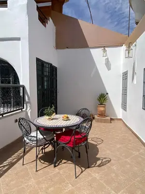 a table and chairs sitting on a patio at Riad DAR OMI ZAHRA in Marrakech