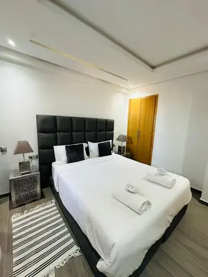 a bedroom with a large bed with two towels on it at Spacieux 2 Chambres Guéliz Centre in Marrakech