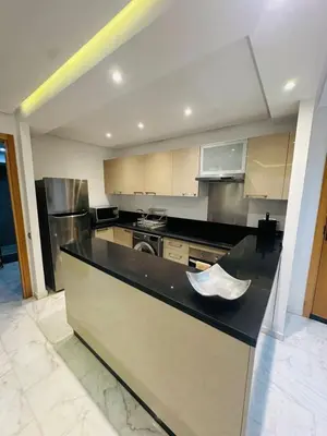 a large kitchen with a counter top and a stove at Spacieux 2 Chambres Guéliz Centre in Marrakech