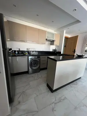 a kitchen with a stove and a washing machine at Spacieux 2 Chambres Guéliz Centre in Marrakech