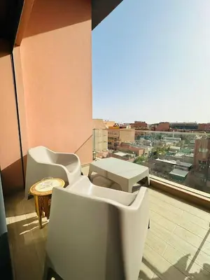 a room with a balcony with a view of a city at Spacieux 2 Chambres Guéliz Centre in Marrakech