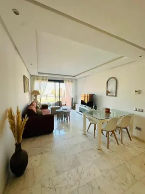 a living room with a couch and a table at Spacieux 2 Chambres Guéliz Centre in Marrakech