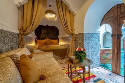 a living room with a couch and a bed at Riad Yalla habibi in Marrakech