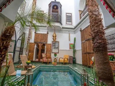 a villa with a pool in the middle of a room at Riad Yalla habibi in Marrakech