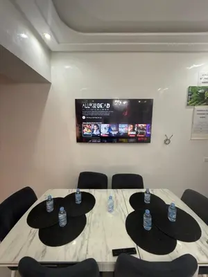 a conference room with a table with chairs and a screen at KSYI IMMO 2 Marrakech Aéroport in Marrakech